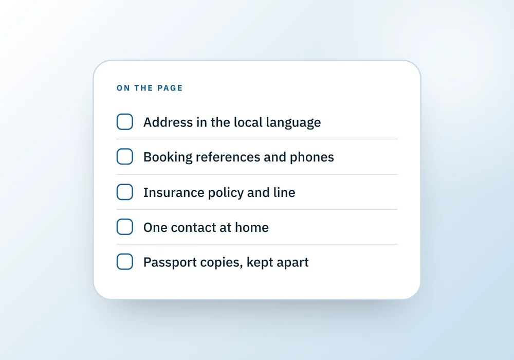 A short checklist of what goes on the one printed travel page: local-language address, booking references, insurance, a home contact, passport copies.
